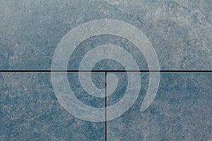 Texture of grey stone wall. Blue background of three blocks