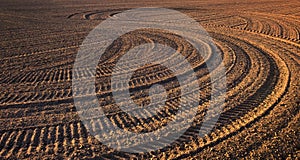 Texture of ground with traces of the tractor. Plowed field