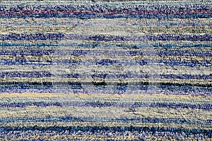 Texture of handmade carpet made on hand-loom, pattern of various blue and white vertical lines