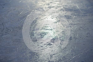 The texture of the ice skating rink, skated, closeup. Open ice rink winter background