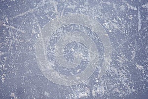 The texture of the ice skating rink, skated, closeup. Open ice rink winter background