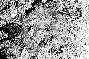 The texture of the ice and snowflakes. The frozen water on black glass. Winter background. Frosty natural snowflake pattern