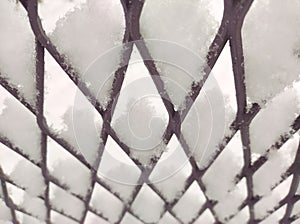 Texture iron chainlink fence snow-covered