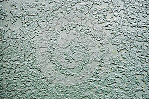 Texture of iron metal painted bright green peeling paint of old battered scratched cracked ancient rusty metal sheet wall