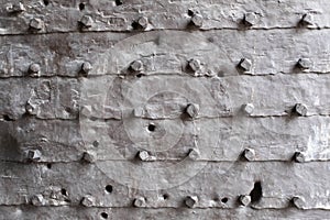 Texture of the iron space, close-up. Background of metal surface from sheets with rivets. A metal relief backing for