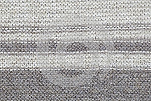 The texture of a knitted brown cloth with stripes. purl and facial loop