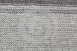 The texture of a knitted brown cloth with stripes. purl and facial loop