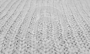 Texture of knitted sweater closeup, white knitted woo