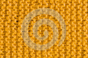 Texture of knitted yellow cloth.