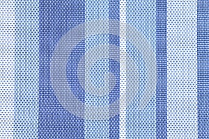 Texture of large weaving close up. Background with light and dark blue stripes. Textile.