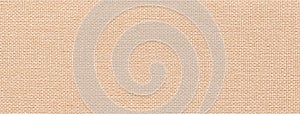 Texture of light beige and cream color background from textile with wicker pattern, macro. Vintage pearl fabric
