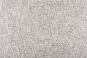 The texture of light beige linen fabric - close-up of a piece of fabric