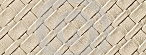 Texture of light beige and sand leather background with wicker pattern. Abstract cream backdrop from textile