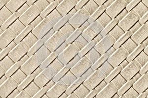 Texture of light beige and sand leather background with wicker pattern, macro