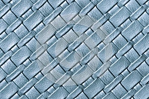 Texture of light blue and denim leather background with wicker pattern, macro