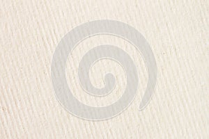 Texture of light cream in a diagonally strip paper with small inclusions for watercolor and artwork. Modern background