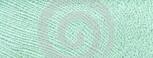 Texture of light pastel green woolen textile background from soft wool material, macro. Structure of cyan fabric