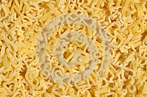 Texture of a lot of curly raw yellow pasta