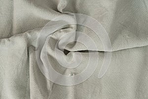 Texture of lused ight gray organic linen fabric closeup