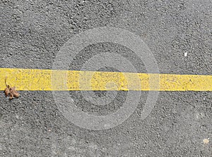 Texture of macadam asphalt with yellow line painted for design, background or wallpaper