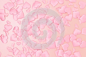 Texture made of textile pink confetti in a heart shape.