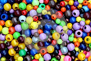 The texture of many bright multicolored beads for needlework.