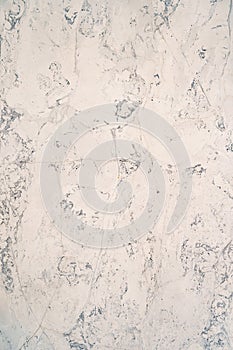 Texture of a marble surface with gray and white streaks close-up.