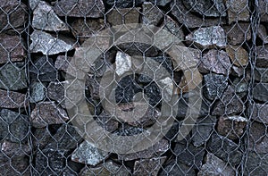 Texture of masonry, background of stone fenced with iron mesh photo