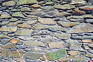 The texture of the masonry wall of natural stone. Detail of a stone wall with different size of rocks