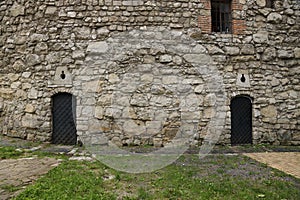 Texture of medieval stone wall and old metal door