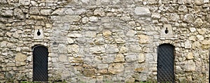 Texture of medieval stone wall and old metal door