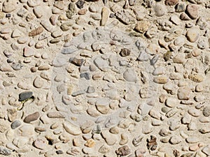 The texture of the medium pebbles is beige.