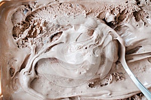 Texture of melting chocolate ice cream. Brown background