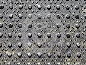 Texture, metal, and design creates abstract art from a floor grate.