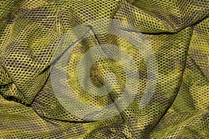 The texture of military camouflage.Military camouflage in a mesh.Camouflage netting.Camouflage background