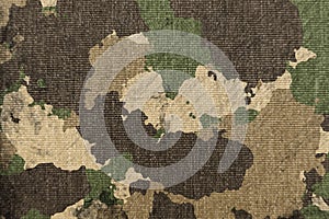 Texture of military dirty camouflage fabric. Combat protective camouflage for background