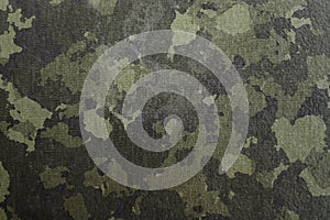 Texture of military dirty camouflage fabric. Combat protective camouflage for background