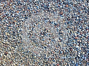 The texture of more colorful stones. Abstract stone background. A variation of colorful pebble and small stones. Texture of