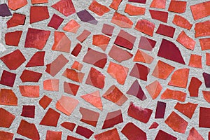 The texture of mosaic wall decorative ornament from ceramic broken tile in orange color, like Gaudi