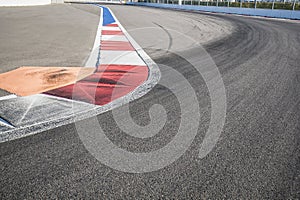 Texture of motor race asphalt and red white curb. Close up on Grand Prix street circuit