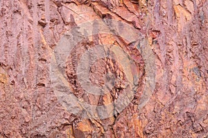 Texture of mountain showing red soil and rock