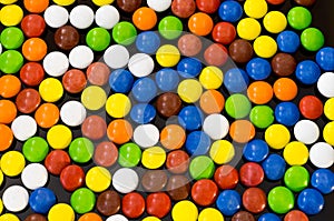 Texture of multi-colored small chocolates. Background of the balls. Multicolored balls.