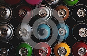 Texture of multi-colored spray cans with paint for graffiti