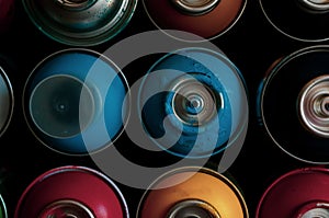 Texture of multi-colored spray cans with paint for graffiti