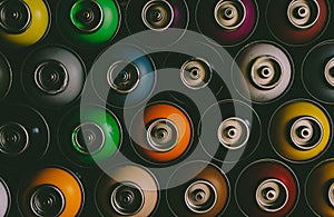 Texture of multi-colored spray cans with paint for graffiti