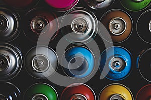 Texture of multi-colored spray cans with paint for graffiti