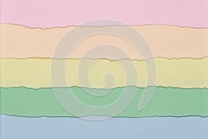 Texture of multicolored paper with torn edges as background