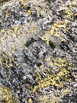 Texture of natural carved solid strong rough textured mineral gray brown stone cobblestone walls of the rock. Stone background