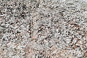 Texture of natural carved solid strong rough textured mineral gray brown stone cobblestone walls of the rock. Stone background