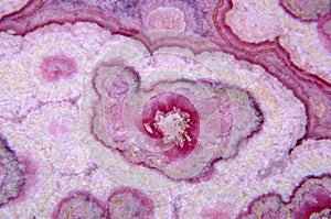 Texture of natural pink rhodochrosite stone closeup photo